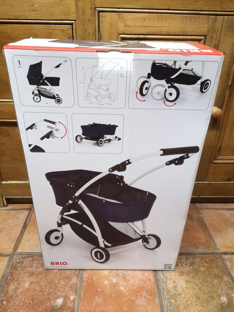 Brio Spin luxury toy pram for dolls & soft toys. Navy blue. Adjustable handle. Great used condition.