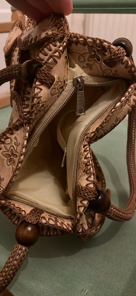 is a vintage-style patchwork bag with a bohemian aesthetic.