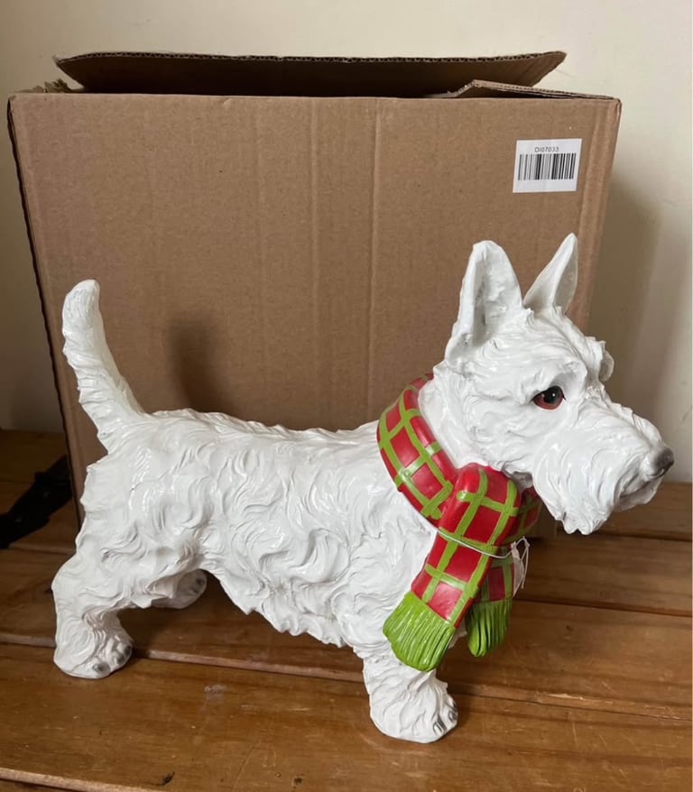 White resin Westie dog ornament wearing a scarf. New in box  Size height 26cm width 31cm depth 14 cm