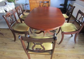 Extending dining room table with 6 chairs, including 2 carvers