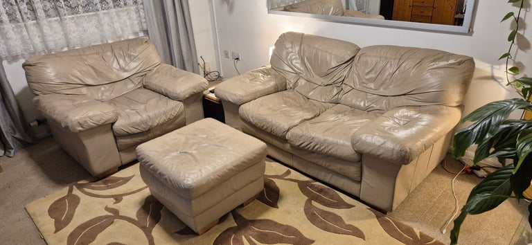 Free cream real leather double sofa with matching armchair and footstool.