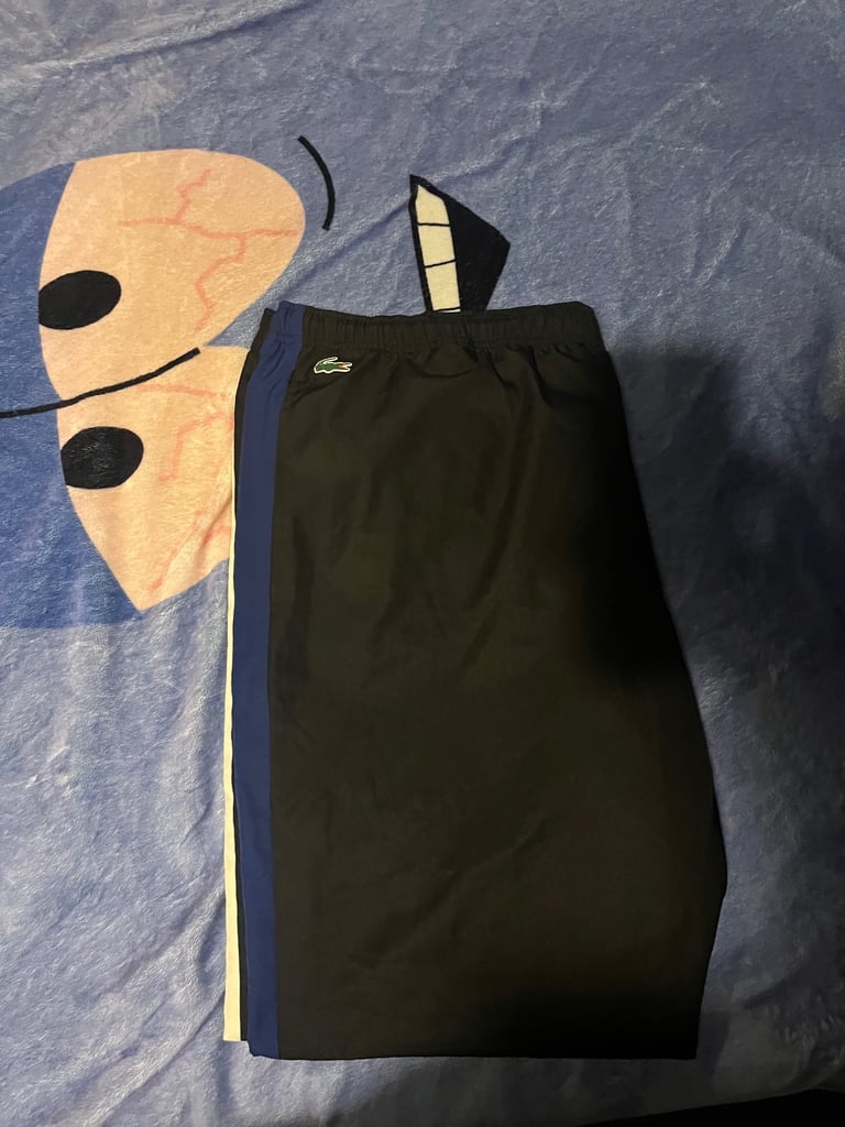 black with white and blue stripe lacoste bottoms