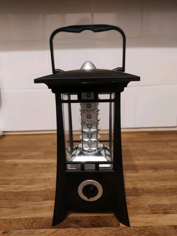 Lantern with rotating dimmer 