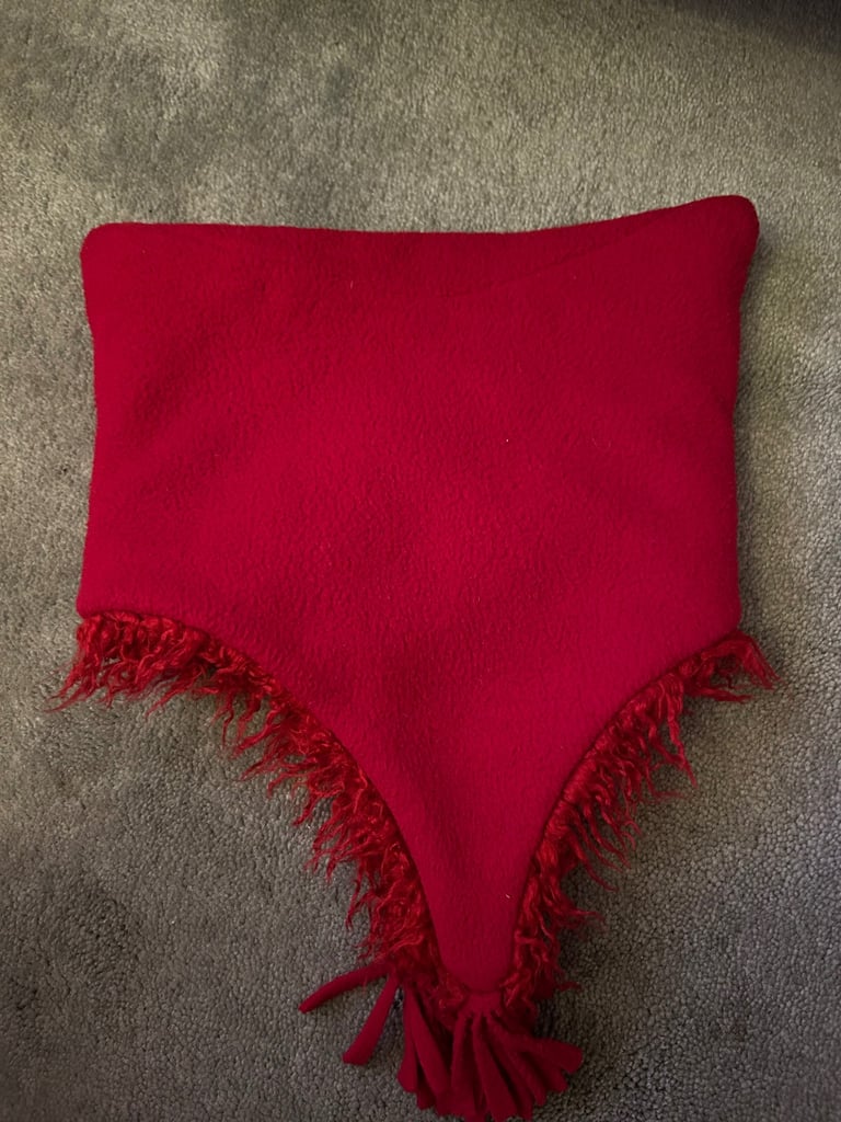 Red fuzzy fleece hat with tassels. .  