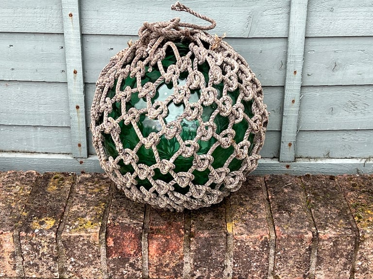 Rare large glass fishing float with rope netting