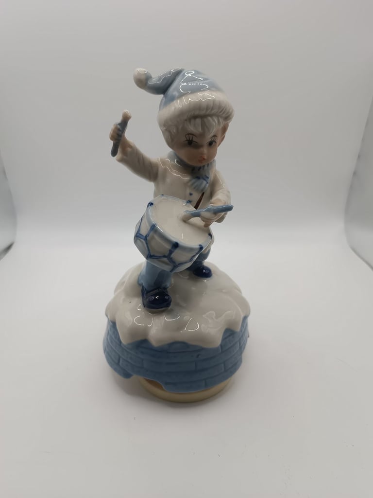 Vintage blue and white ceramic music drummer boy. Turns and music plays