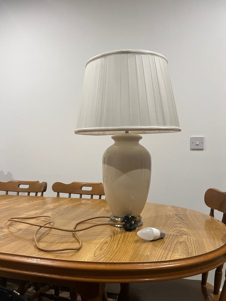 Pair of Dunelm Off white ceramic lamp with brass fixtures .