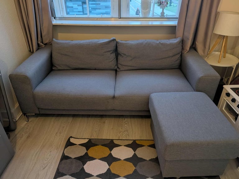 image for This is a grey fabric sofa with a matching footstool.