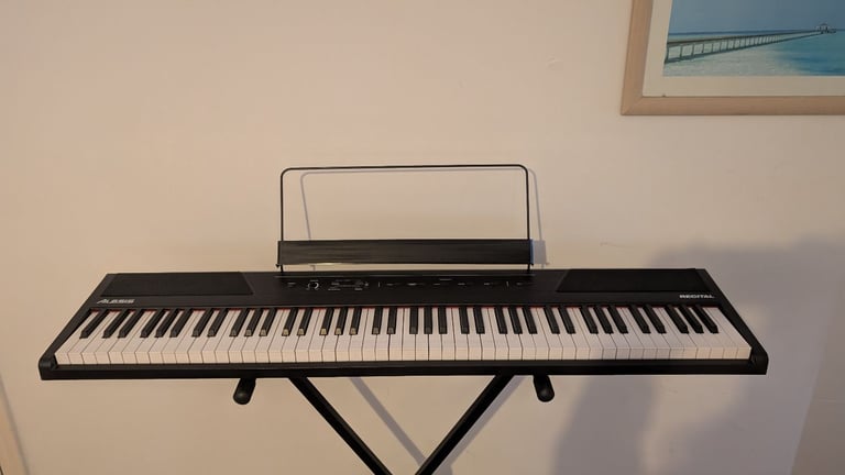 Alesis 88 key semi-weighted keyboard with stand and sustain pedal included