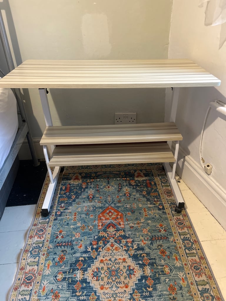 Adjustable height desk with wheels and shelves