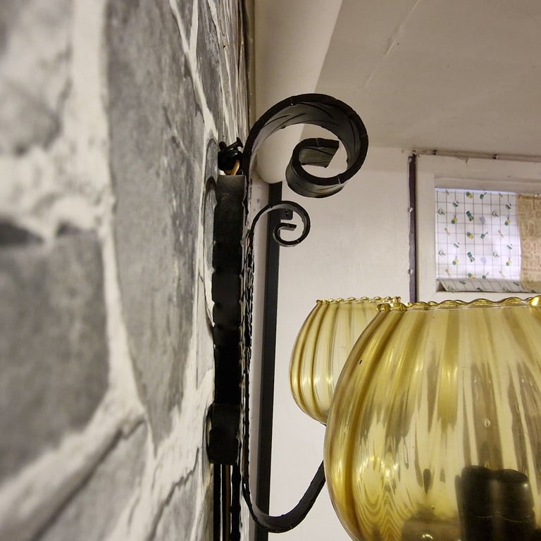 Pair of Vintage Wrought Iron Wall Sconces with Amber Glass Shades
