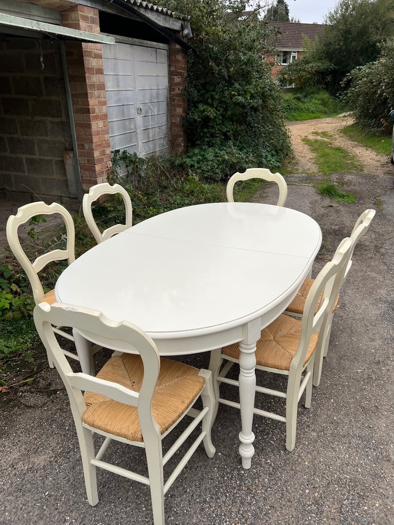 M&S Dining Table - Cream with wicker chairs. six chairs and an extender