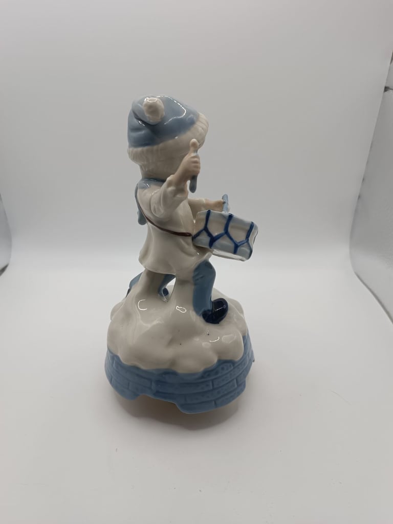 Vintage blue and white ceramic music drummer boy. Turns and music plays