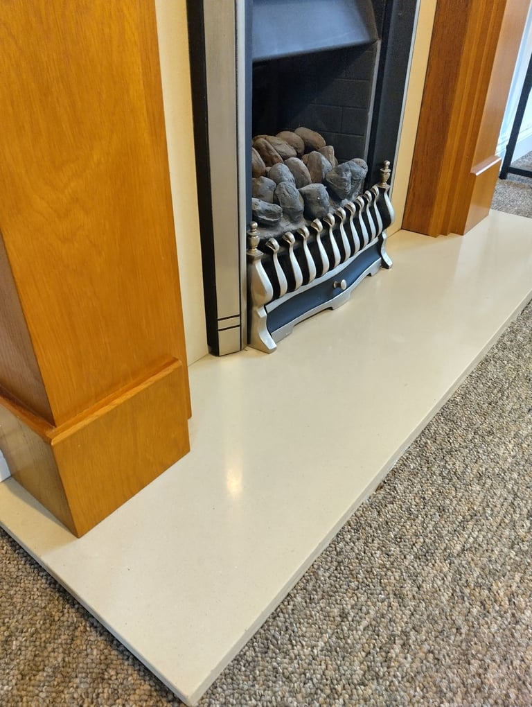 Gas fire with hearth and wood surround