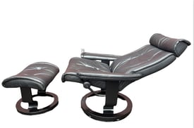 Vintage Black ekornes stressles recliner chair and footstool 