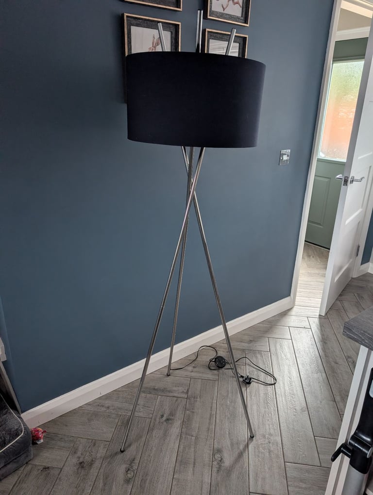 Silver tripod floor lamp with navy lampshade 