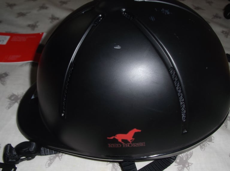 Childs horse riding safety helmet and storage bag