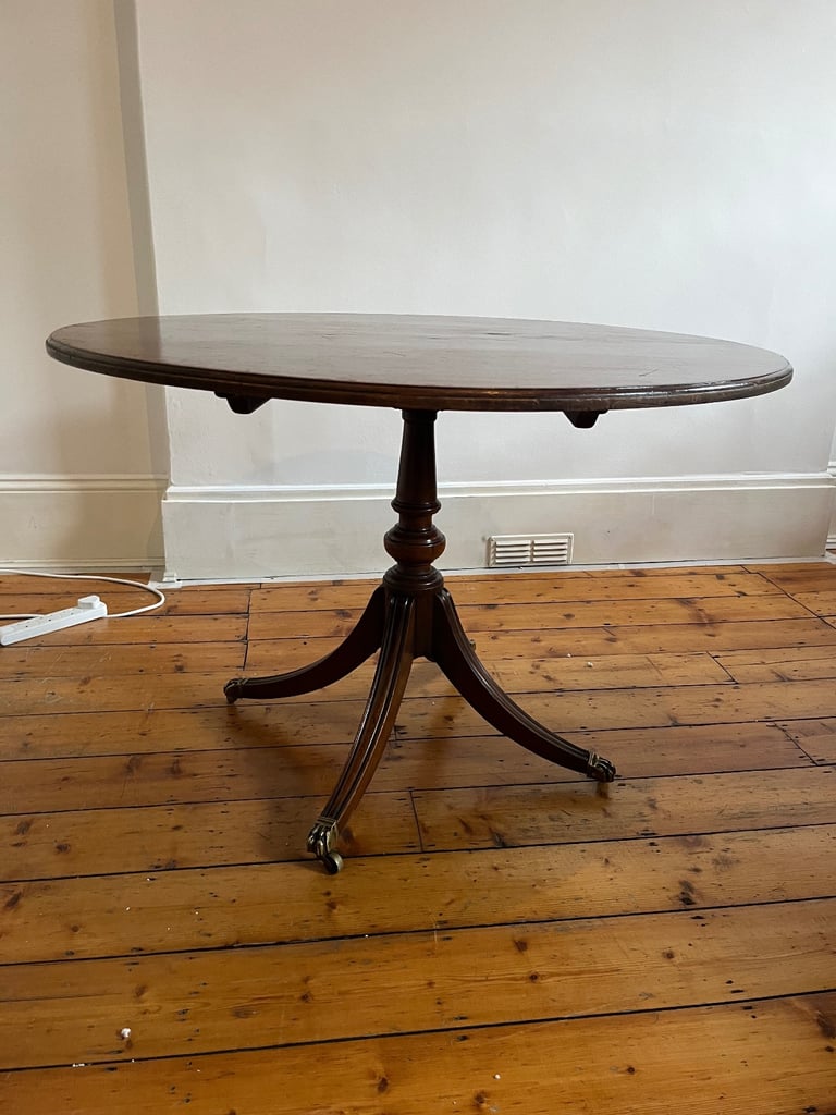 oval antique dining table on tripod leg