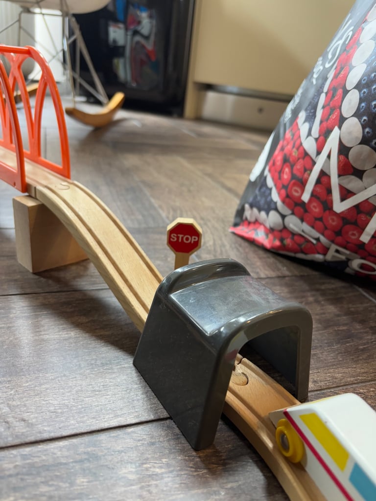 A bag full of wooden train track elements with many extras