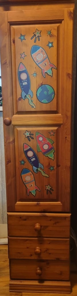 Tall slim cupboard with drawers hanging rail and separate storage 