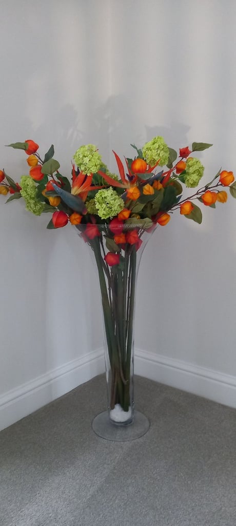 image for Lovely green and orange flower arrangement in glass vase