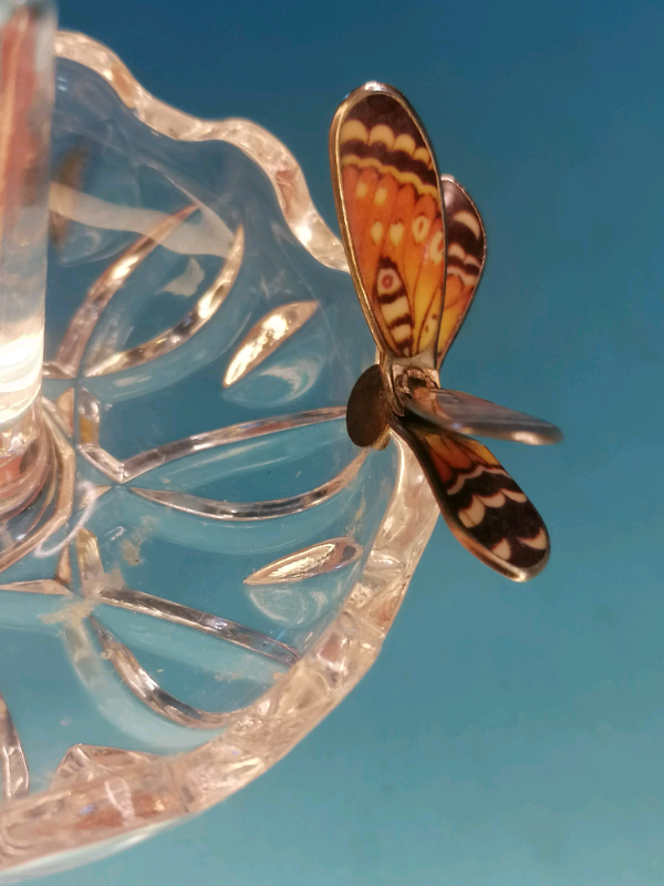 Glass ring holder with butterfly on  a side..