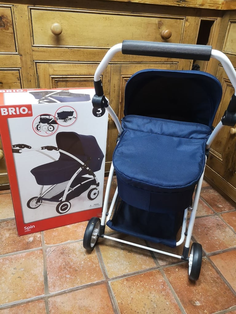 Brio Spin luxury toy pram for dolls & soft toys. Navy blue. Adjustable handle. Great used condition.
