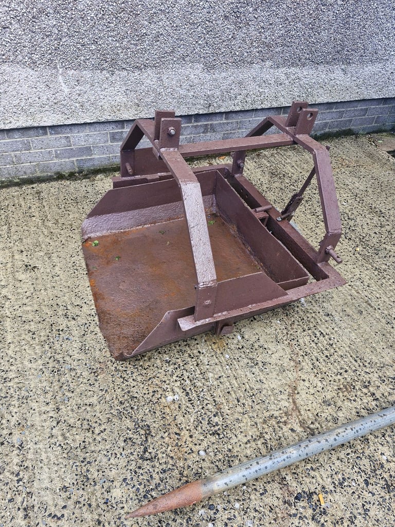 Earth scoop and buck rake.