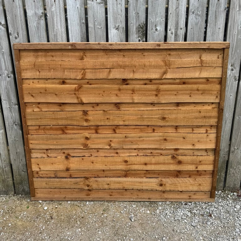 image for Heavy duty brown waneylap fence panels, tanalised, pressure treated