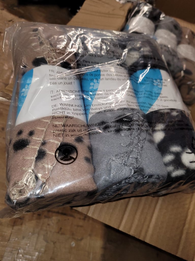 A new still packed pack of 3 pet blankets .