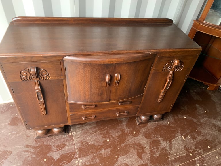 image for Elegant vintage wooden art deco sideboard with intricate carvings.