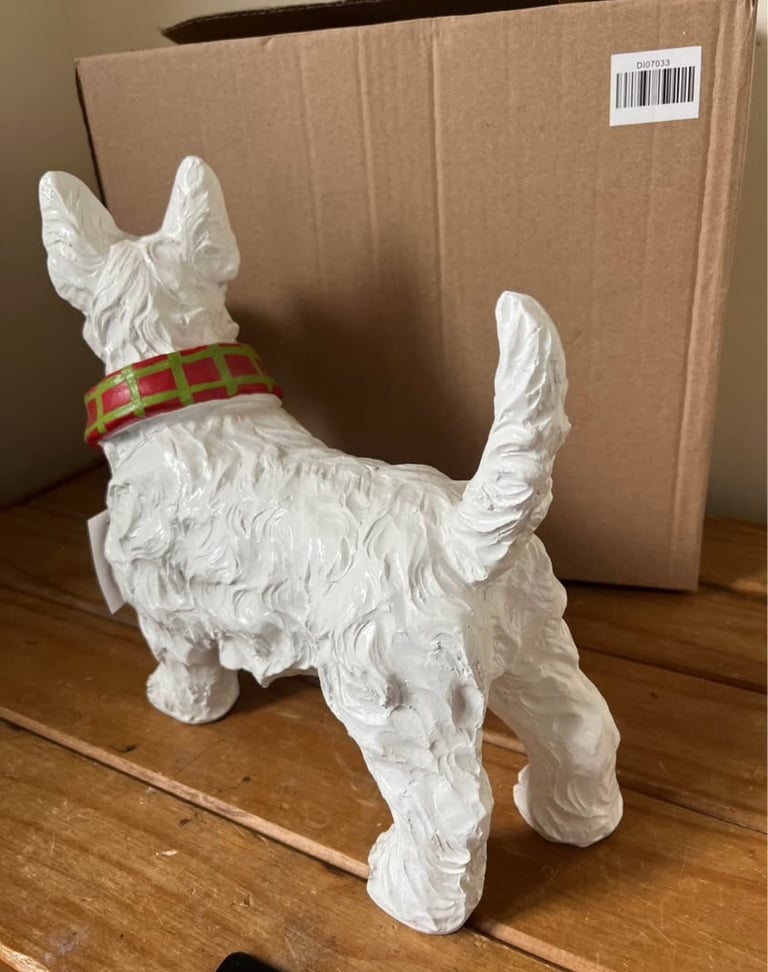 White resin Westie dog ornament wearing a scarf. New in box  Size height 26cm width 31cm depth 14 cm