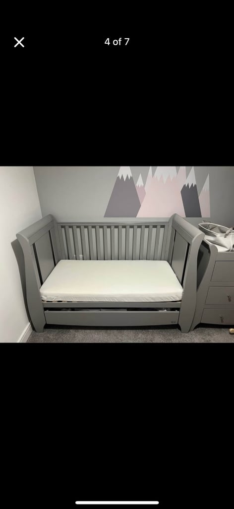 Grey cot bed with mattress available 