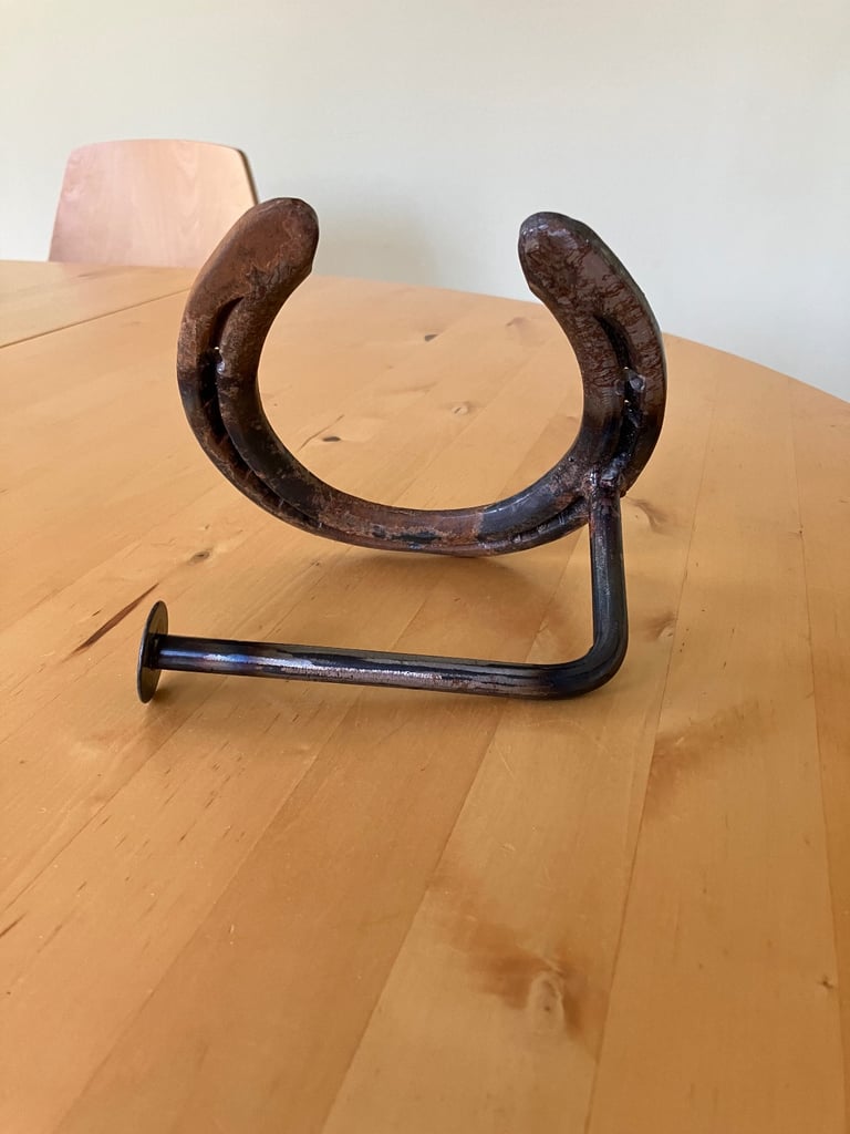 Horse shoe toilet paper holder