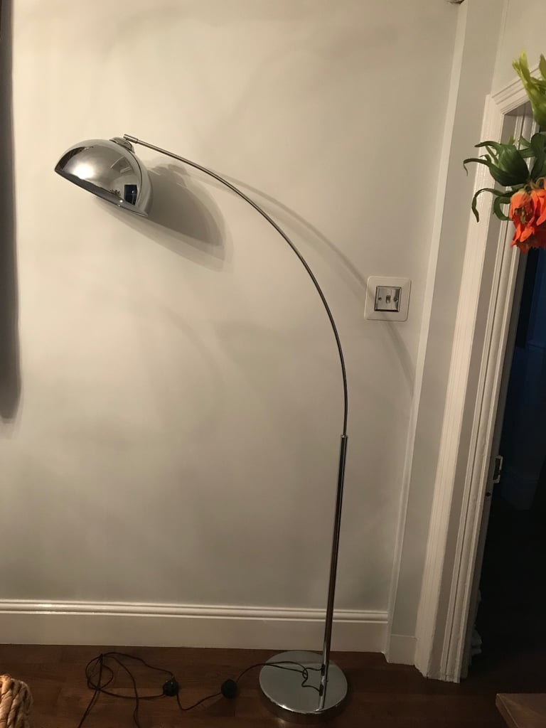 Floor standing chrome overhang light.