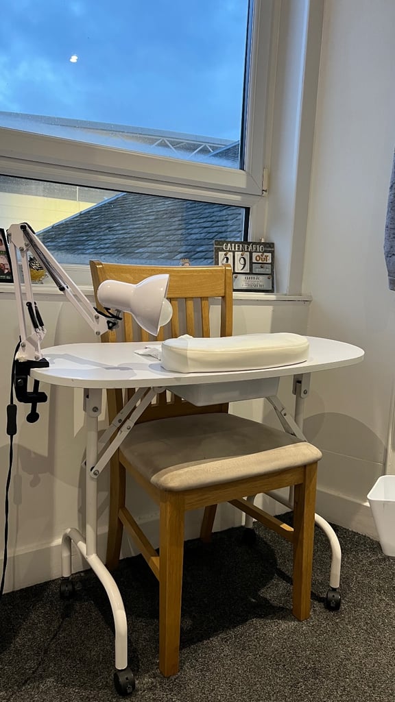 Manicure table with drawer and built-in lamp.