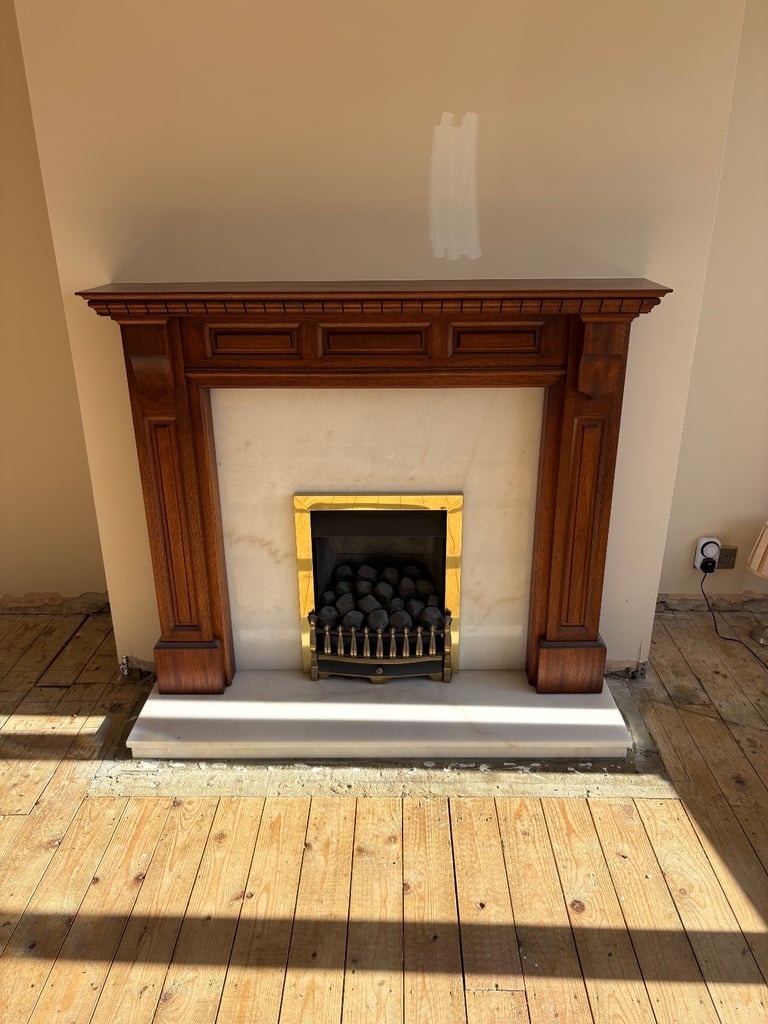 Wooden fireplace with gas inset fire