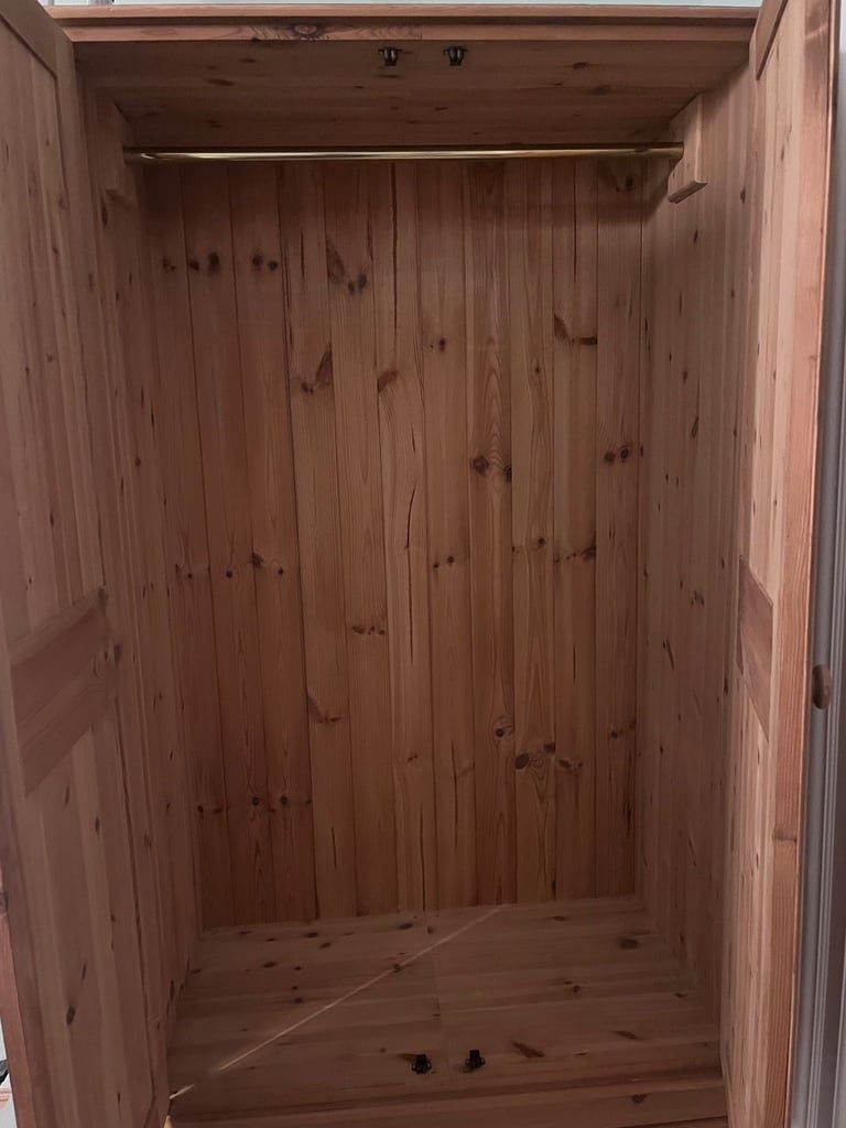 Wooden wardrobe with hanging rail and one drawer 