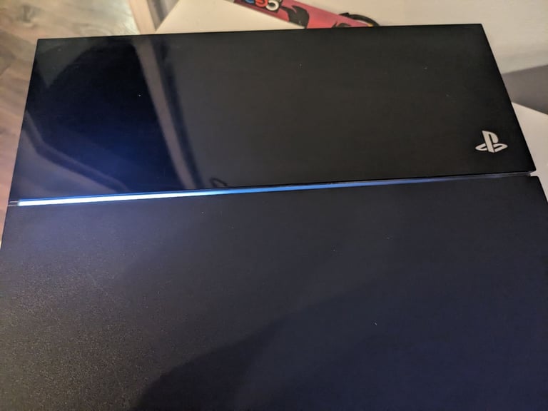 PlayStation 4 console and two controllers 