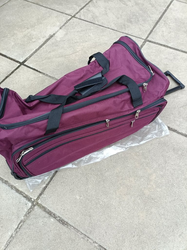 New large purple holdall on wheels pull along handle 