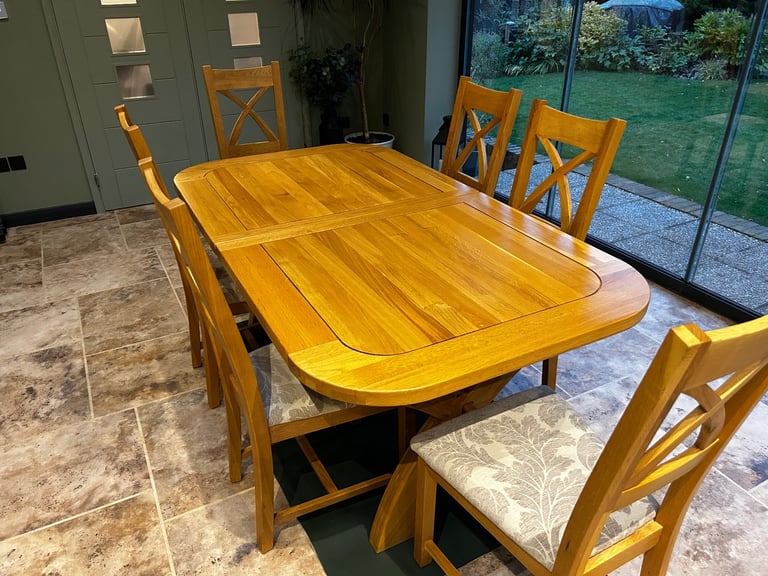 Solid oak dining table and six chairs