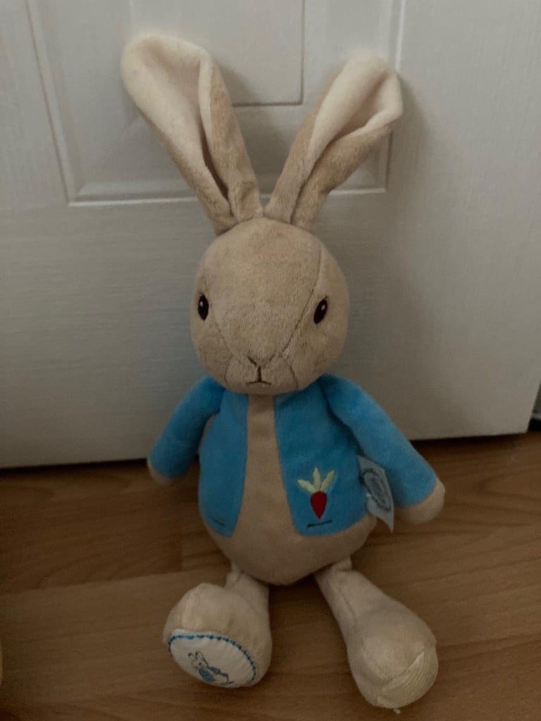 Selection of soft toys inc Peter rabbit bunny, giraffe, Winnie the Pooh and animal stacking ring