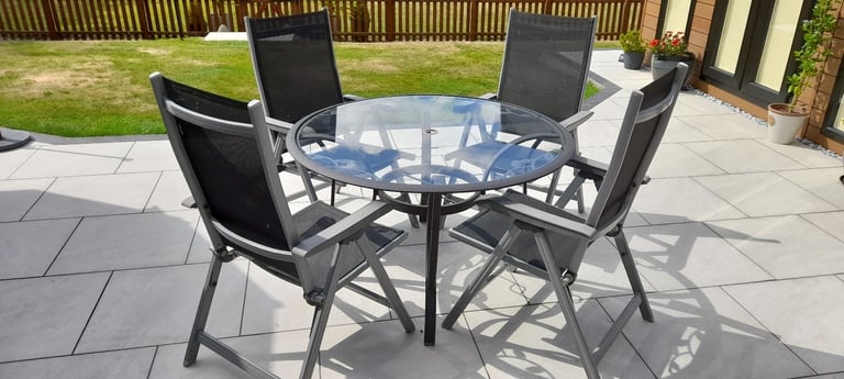 image for Used Round glass top patio table and 4 chairs