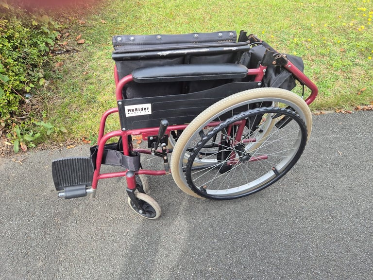 Self propel wheelchair. Brakes on handle. Lap belt. Wheel chair