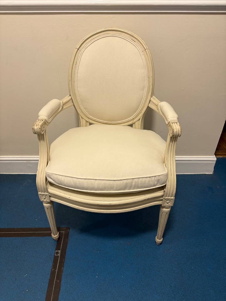 Louis XVI-style Medallion Armchair with a distressed white finish and upholstered cushions