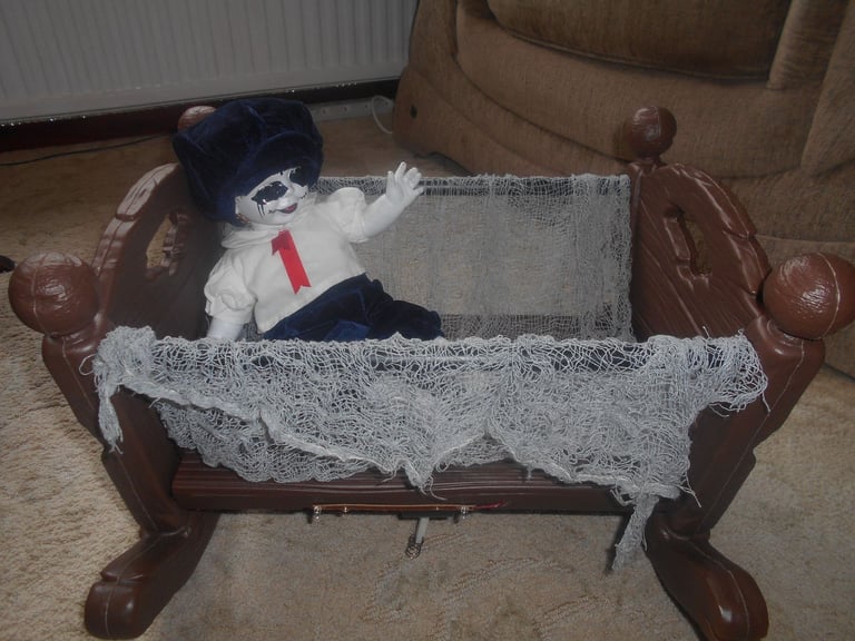 image for Spooky rocking crib with doll