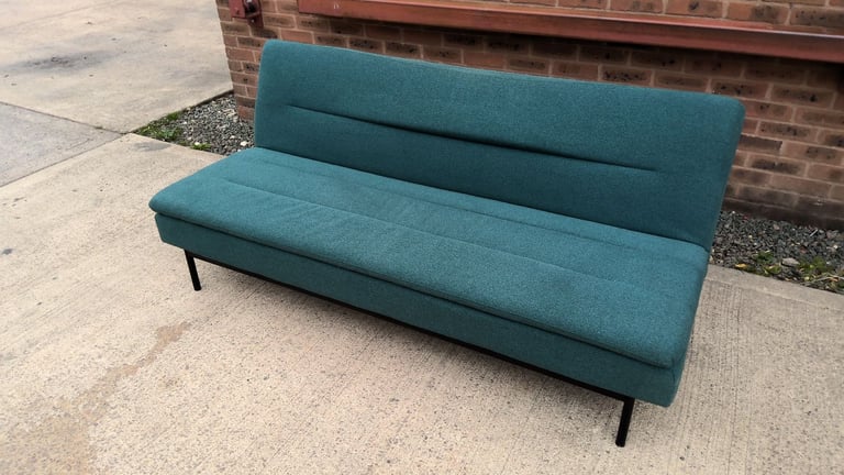 green 2 seater sofa that folds down to be a sofa bed 