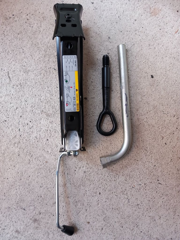 New car jack with wheel spanner and towing eye.  