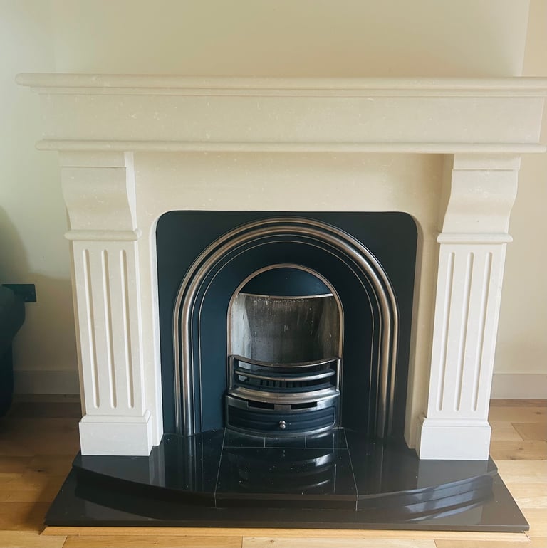 Marble fireplace with black cast iron insert and granite hearth
