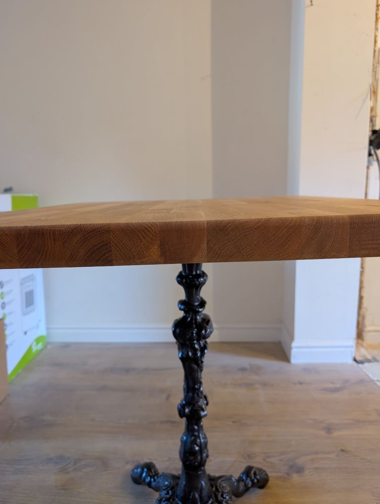 Solid Oak dinner table with cast iron base
